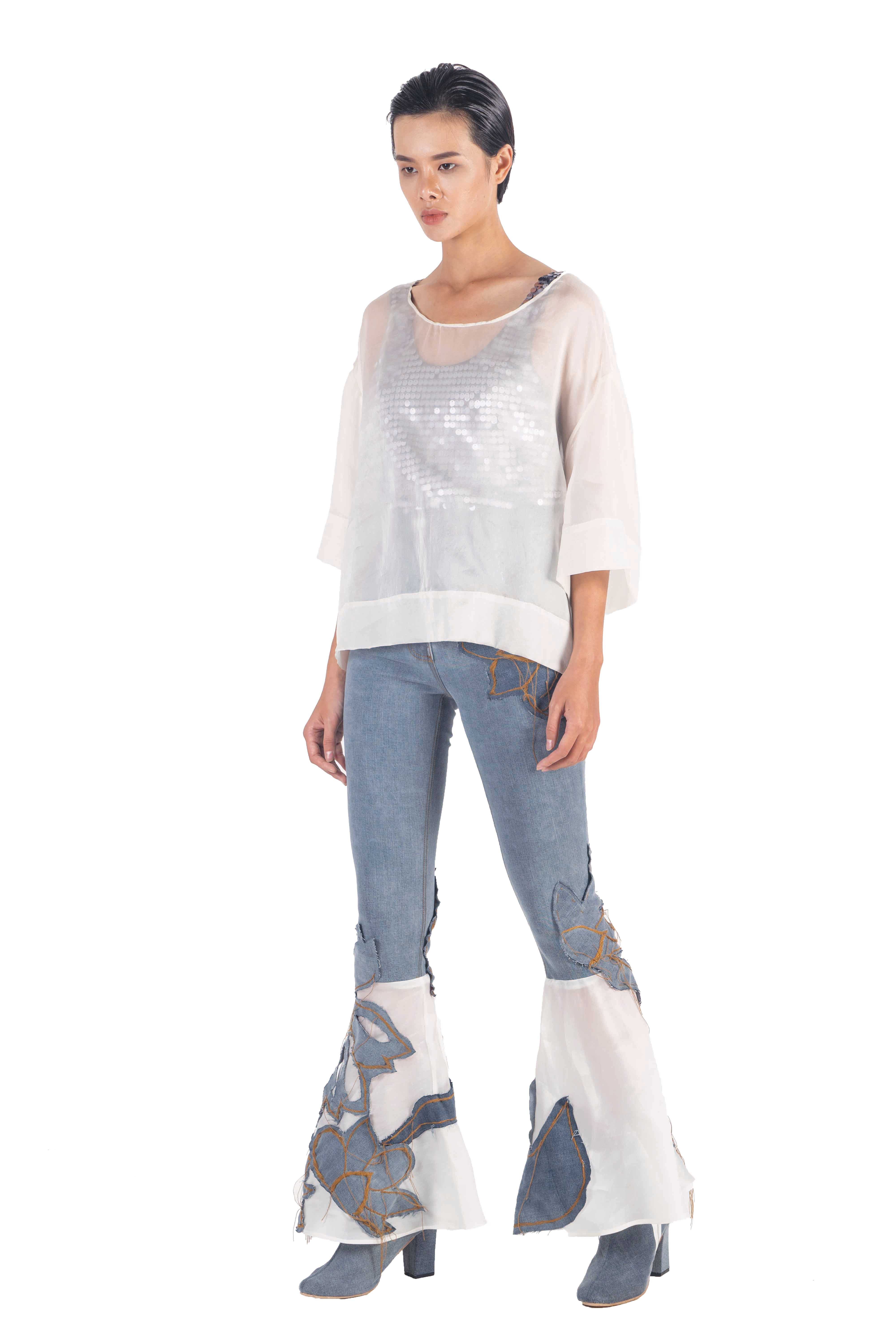 Washed denim pants with contrasting flaired white silk organza bottom panels